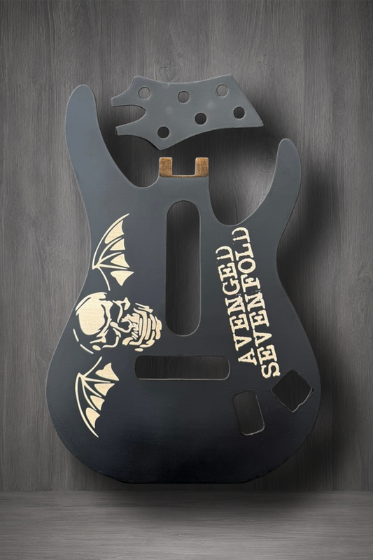 A matte black MagnaPlate body and matching headstock. The body features a laser engraved graphic of a skull and bat with the text 'AVENGED SEVENFOLD' printed vertically.