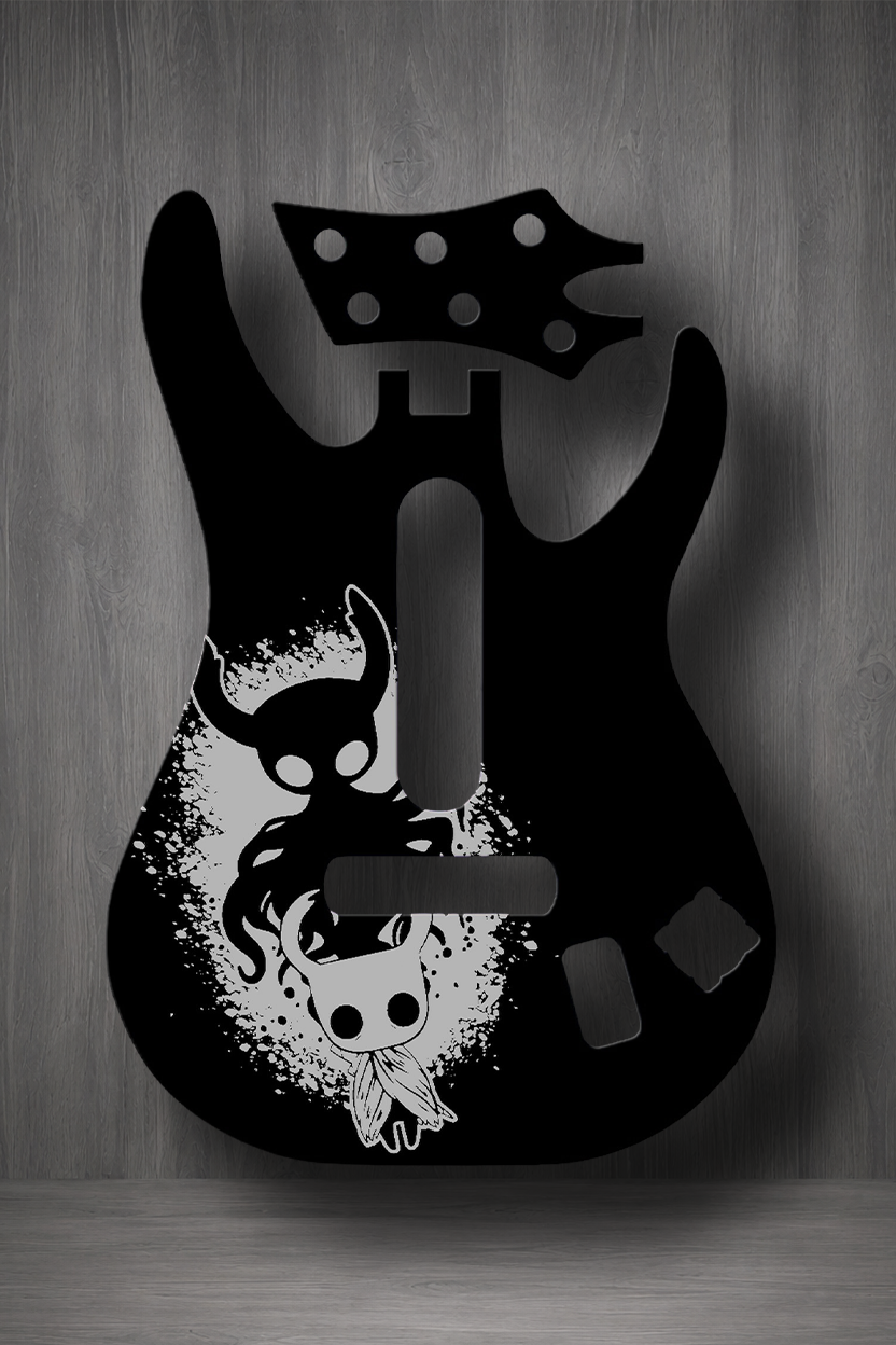 A black electric guitar body silhouette with a stylized white skull and horned figure graphic, shown against a gray wood-textured background.