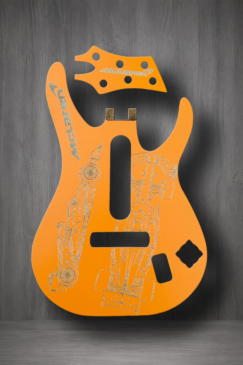 A Papaya Orange guitar body and matching headstock MagnaPlate set. The body features light gray technical line drawings and the brand name 'Majestic' printed vertically on the upper left side.