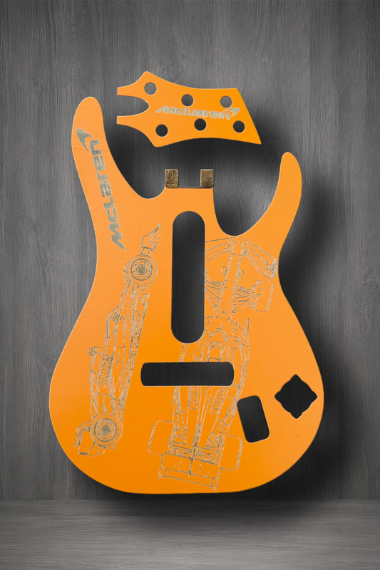 A Papaya Orange guitar body and matching headstock MagnaPlate set. The body features light gray technical line drawings and the brand name 'Majestic' printed vertically on the upper left side.
