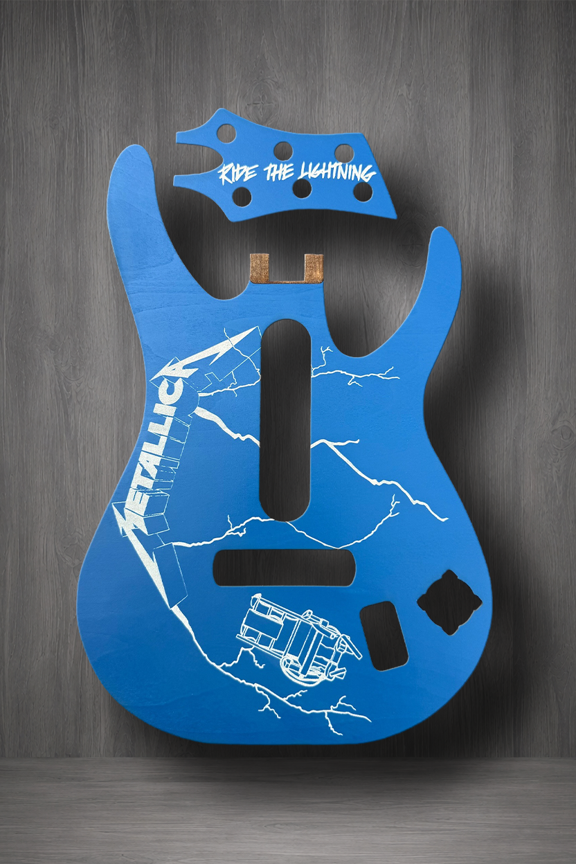 A blue guitar body MagnaPlate set with white Metallica graphics, including the 'Ride the Lightning' logo on the headstock area, 'METALLICA' on the body, and lightning bolt designs